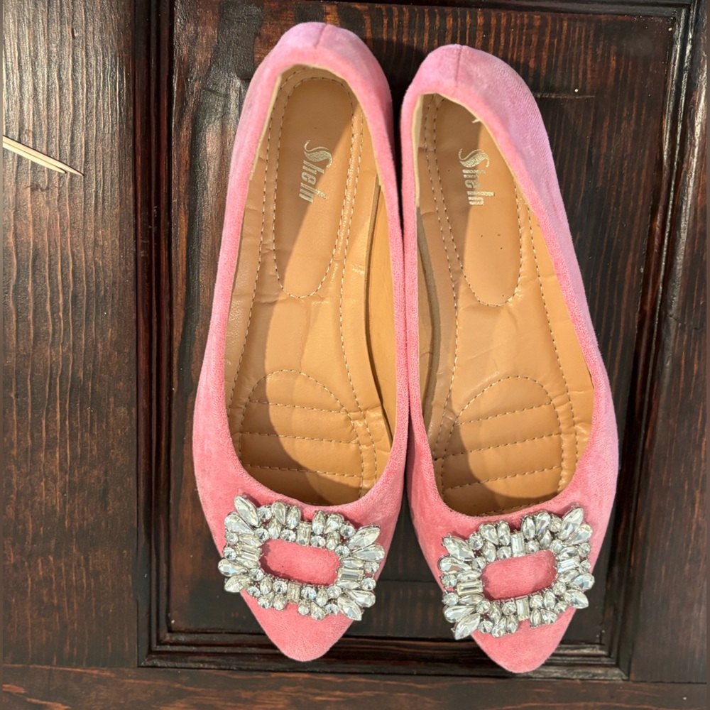 Hot pink flats with rhinestone detail.